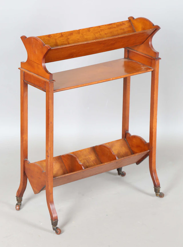 An Edwardian satinwood book trough, raised on splayed block supports