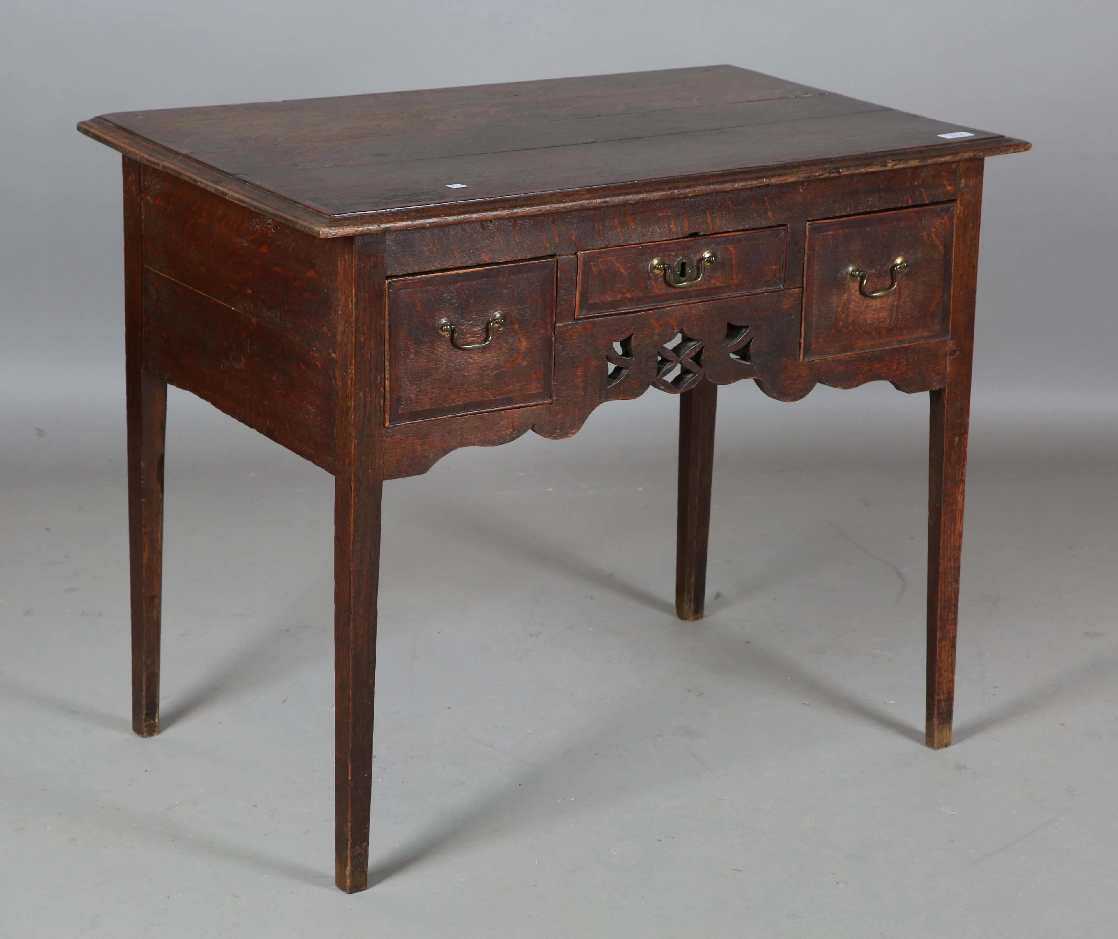 A George III provincial oak side table, the crossbanded top above