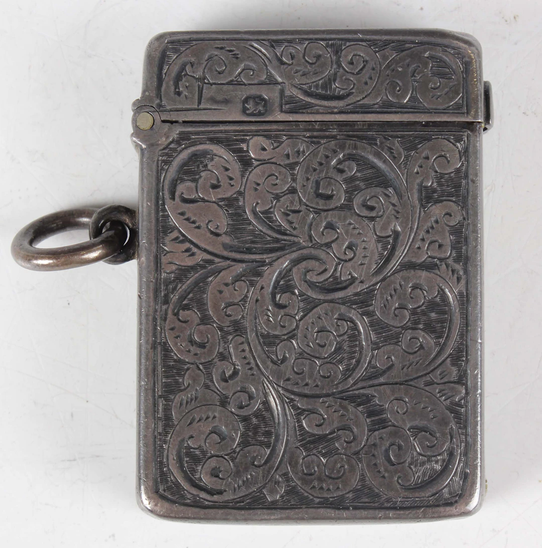 A late Victorian silver vesta case, engraved with foliate scrolls