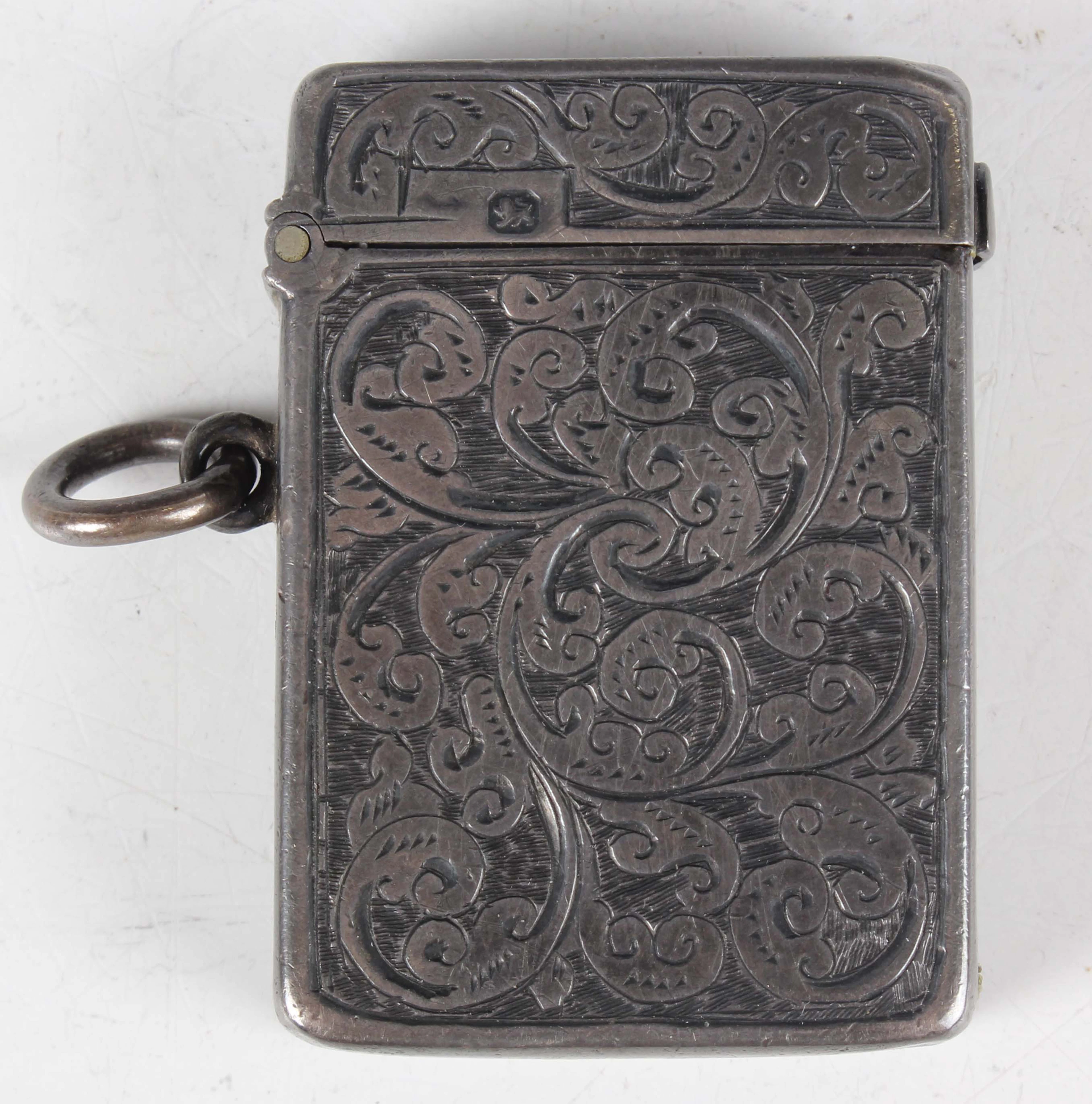 A late Victorian silver vesta case, engraved with foliate scrolls