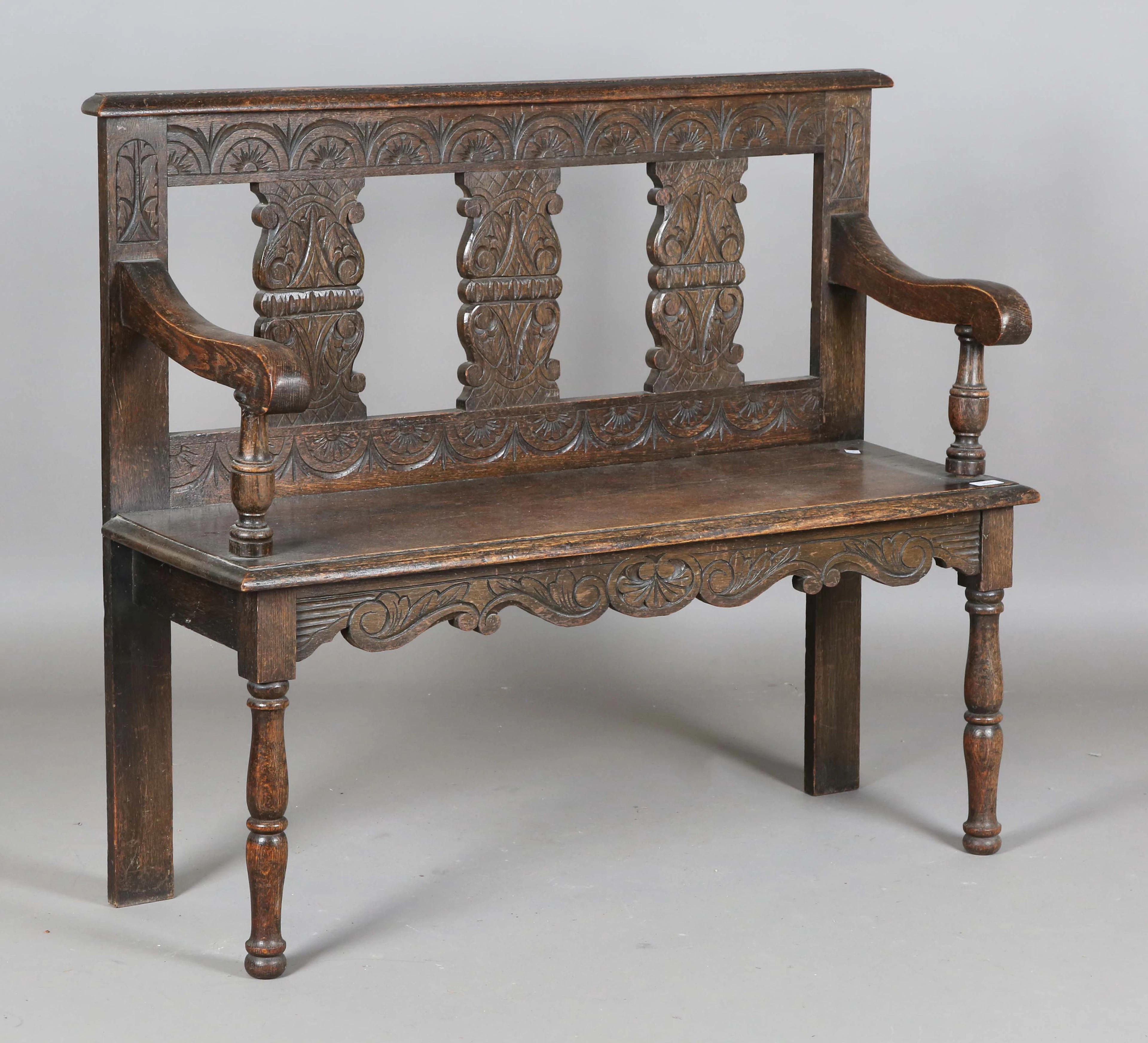 A late Victorian Carolean Revival carved oak hall bench, height 93cm