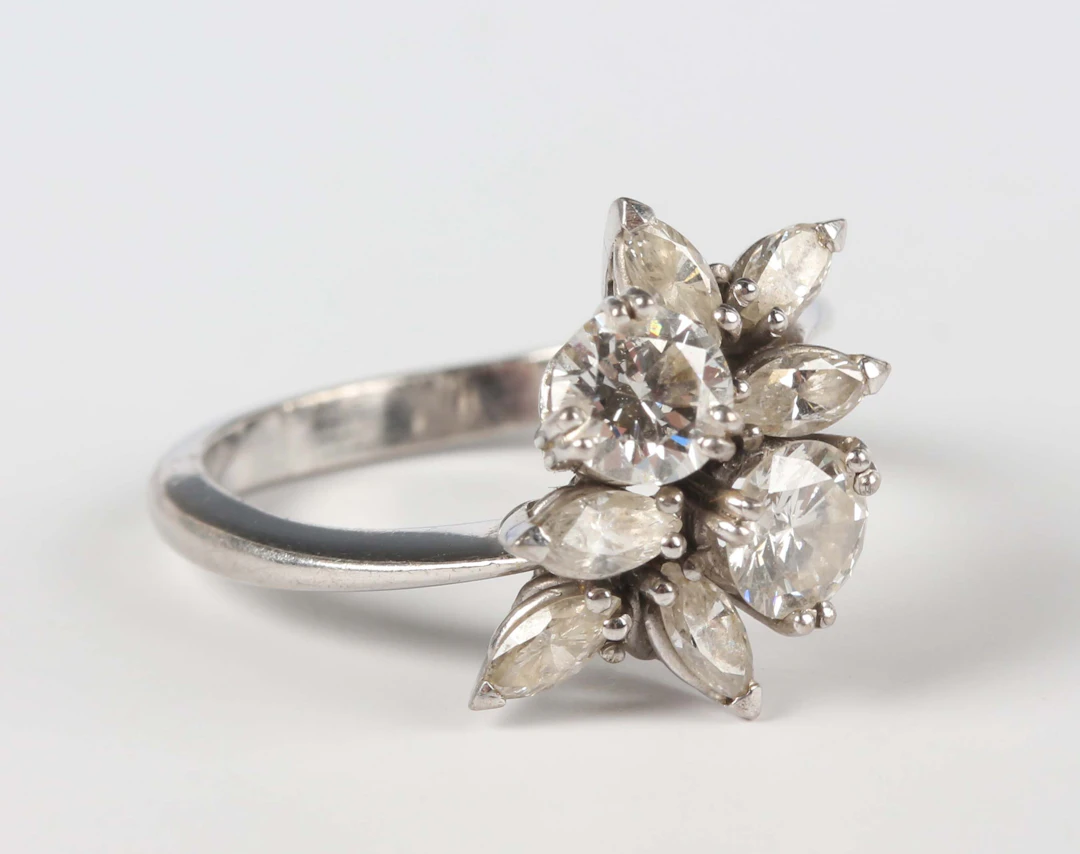 A white gold and diamond ring, claw set with the two principal circular
