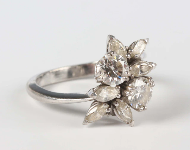 A white gold and diamond ring, claw set with the two principal circular