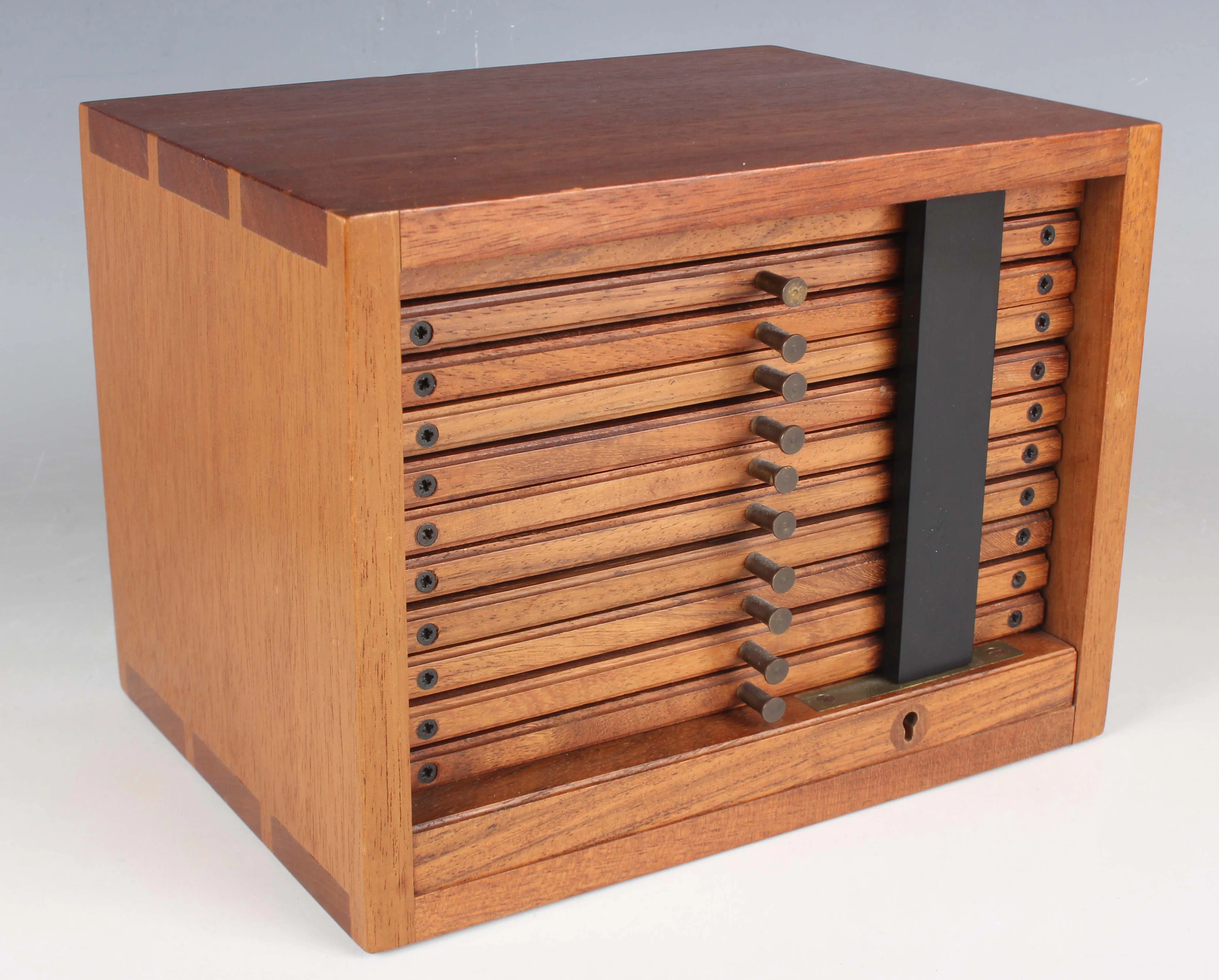 A mid-20th century Swann mahogany coin collector's chest with an arrangement