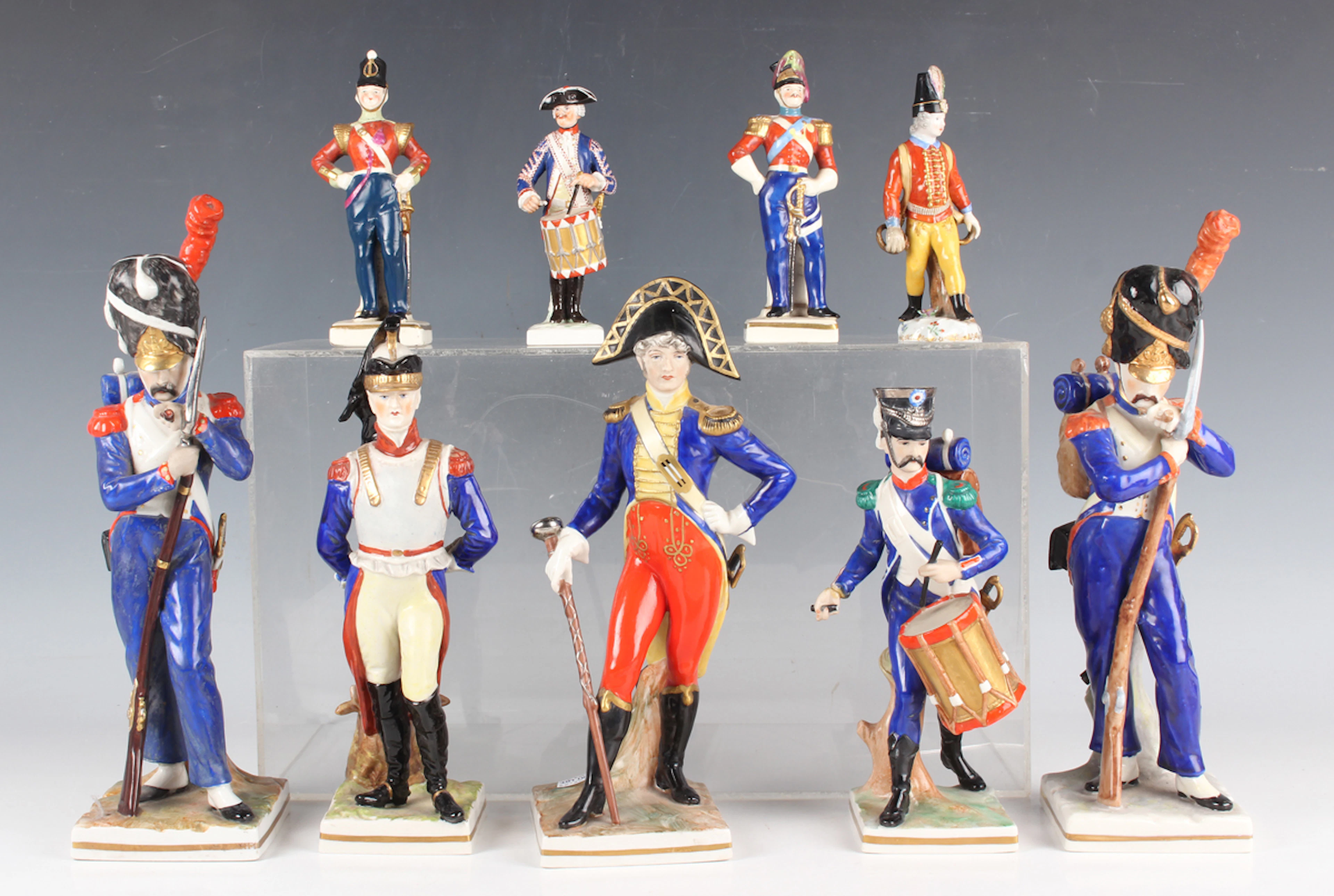 Nine Continental porcelain military style figures, late 19th century