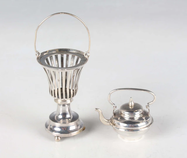 A Dutch miniature toy silver kettle and stand, the kettle of compressed