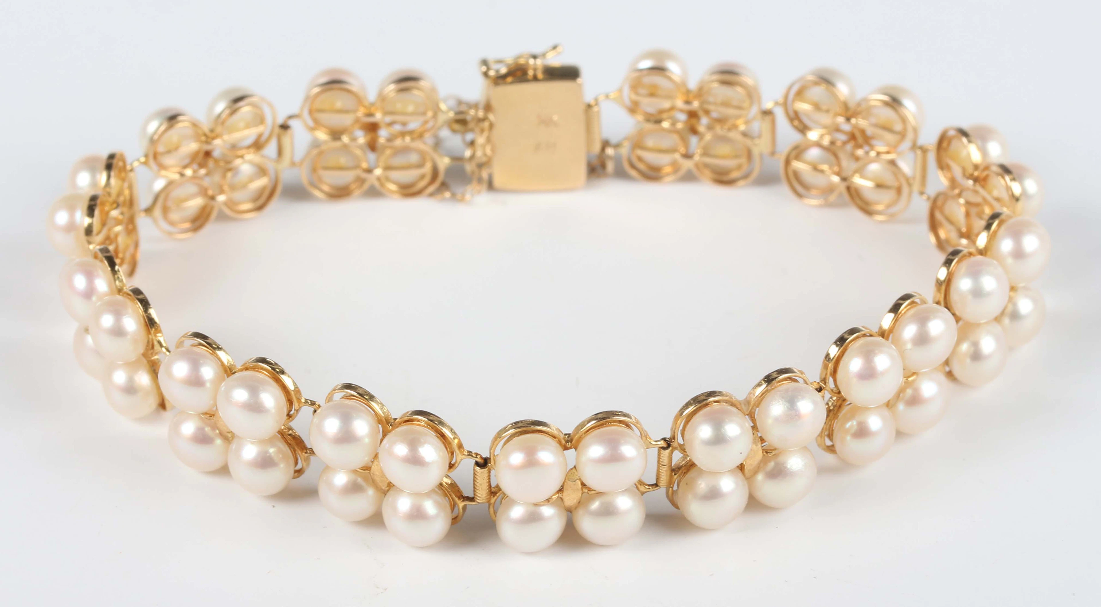 A gold and cultured pearl bracelet, designed as thirteen panels, each