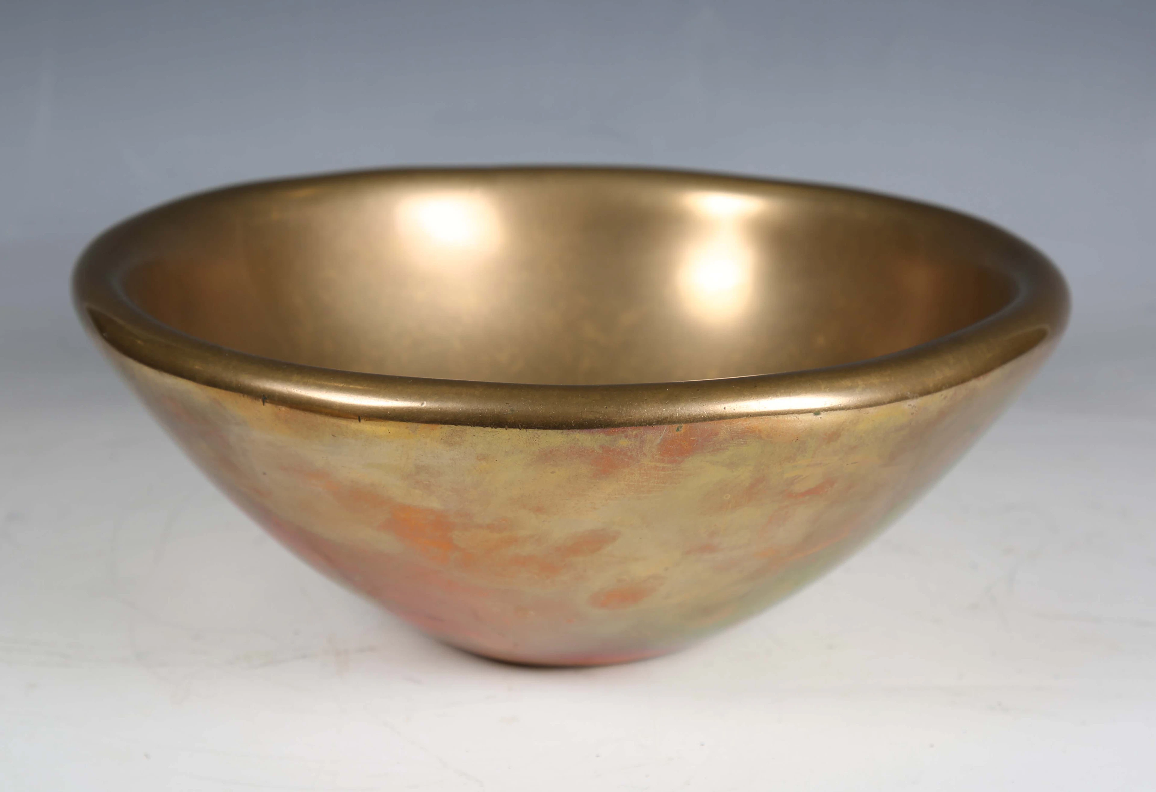 A modern bronze bowl of circular form, bearing stamped monogram and