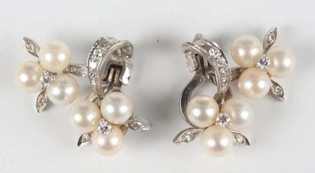 A pair of white gold, cultured pearl and diamond earclips, each mounted