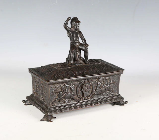 A 17th century Italian style cast bronze casket, the hinged lid with