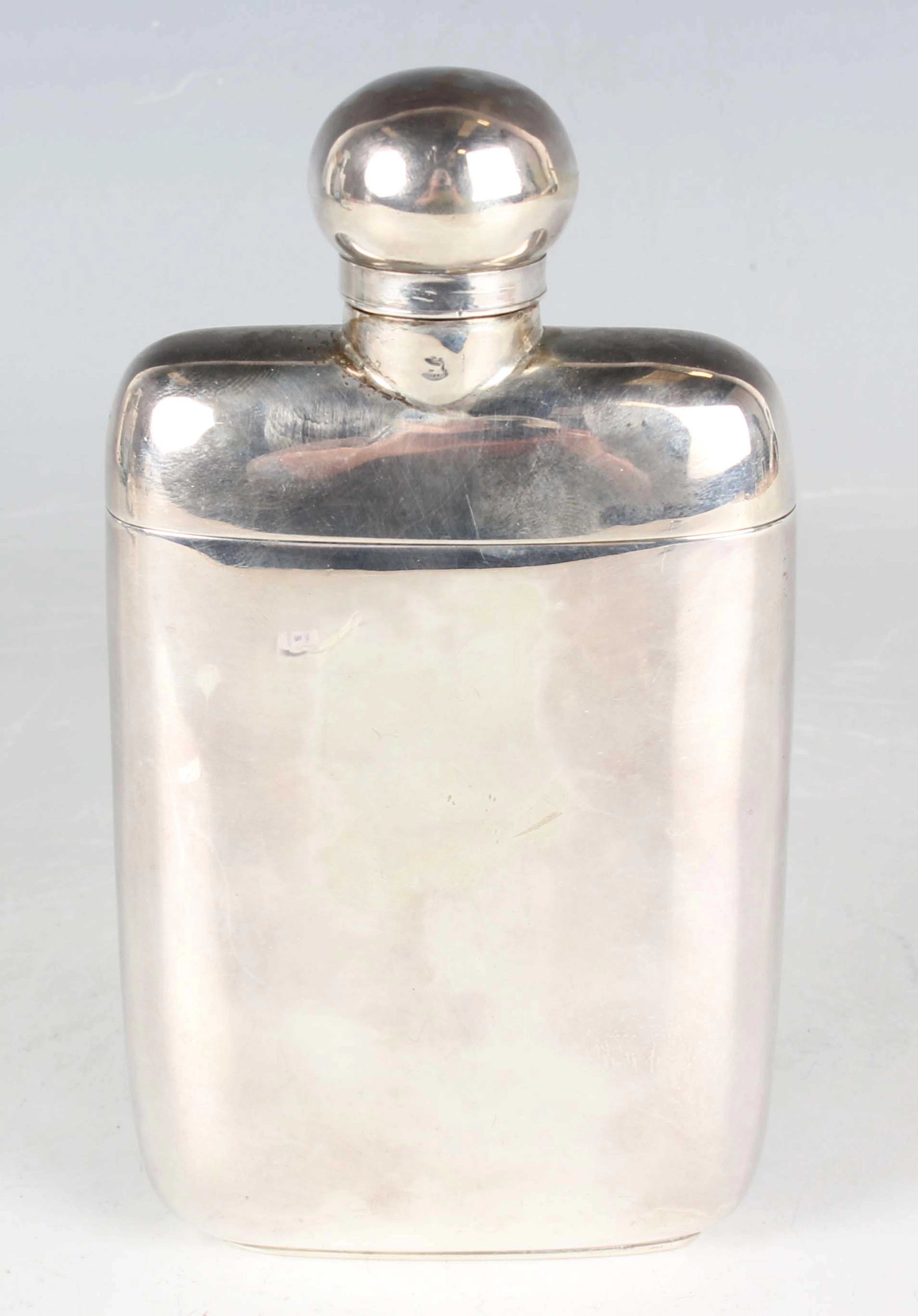 A late Victorian silver hip flask with rotating hinged lid and detachable