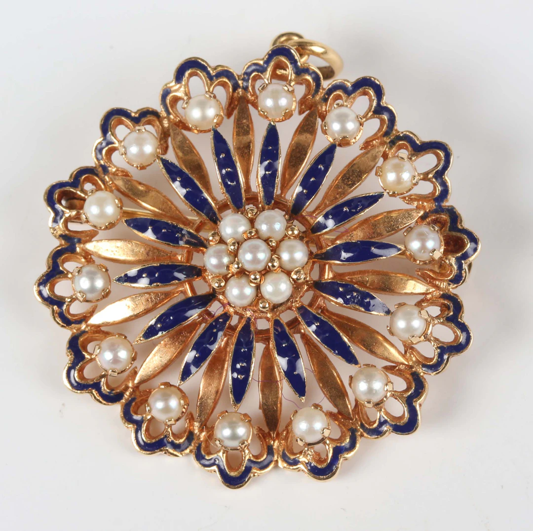 A gold, cultured pearl and blue enamelled pendant brooch in a flowerhead