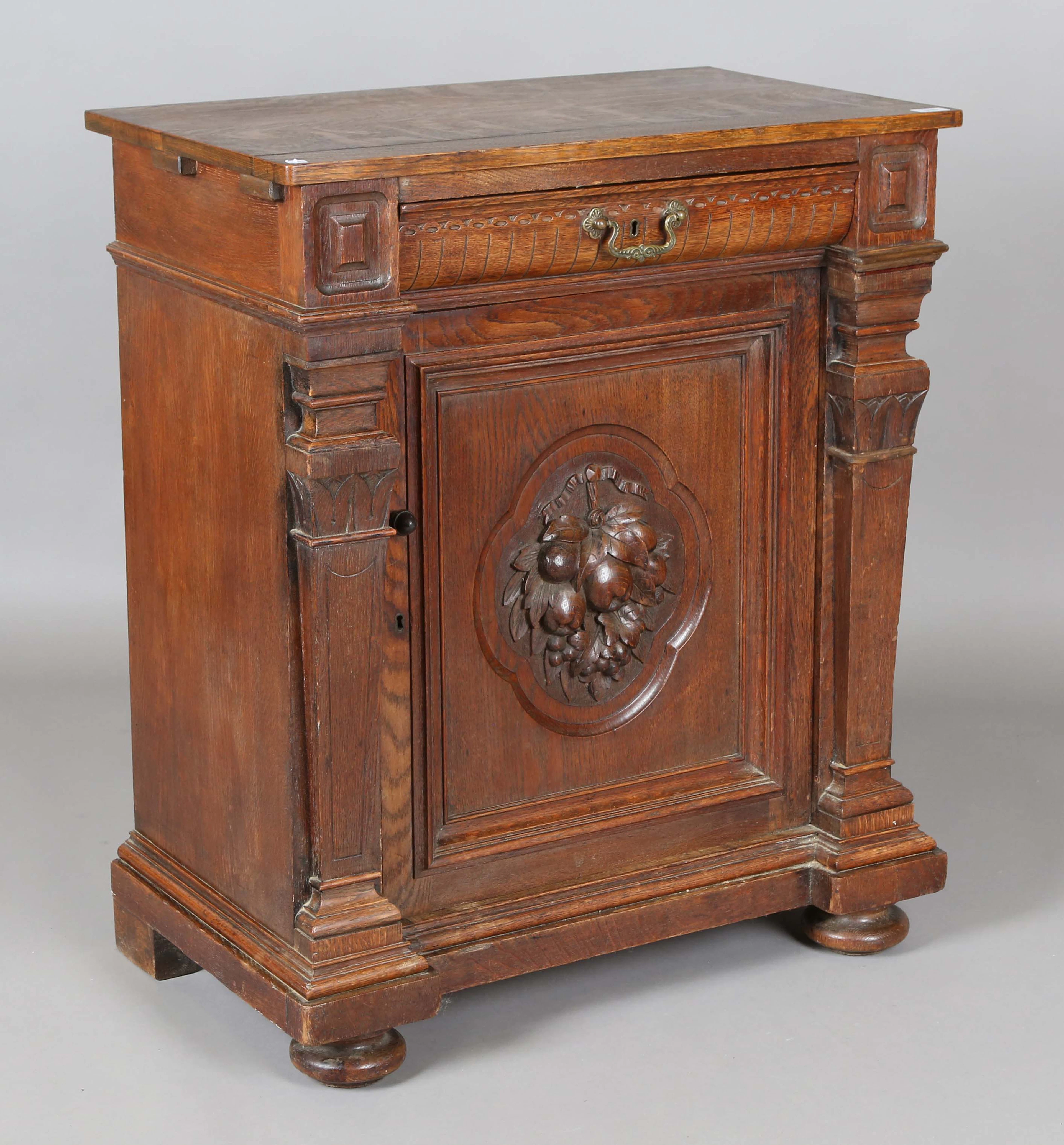 A late Victorian oak side cabinet, fitted with a drawer above a cupboard