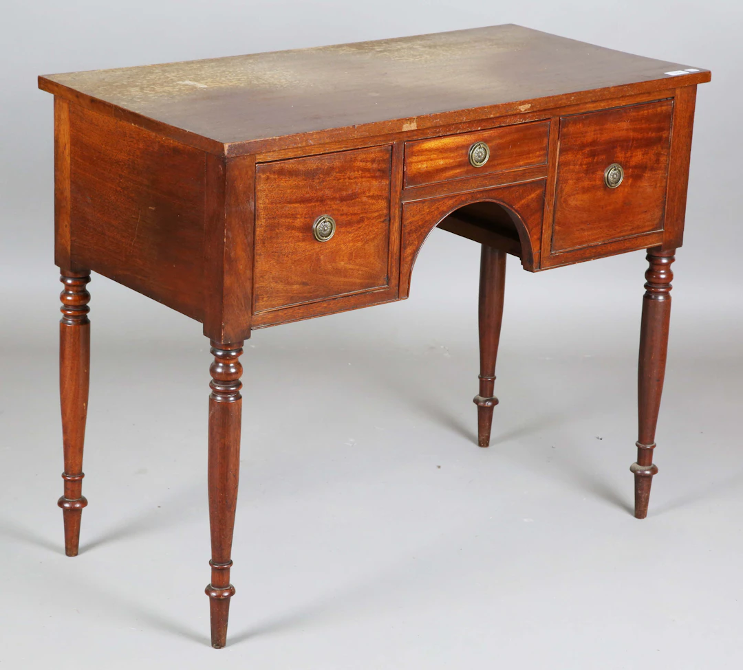 A George IV mahogany kneehole side table, fitted with three drawers