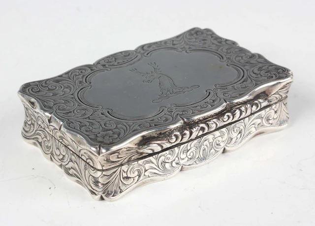 An early Victorian silver rectangular snuff box with shaped outline