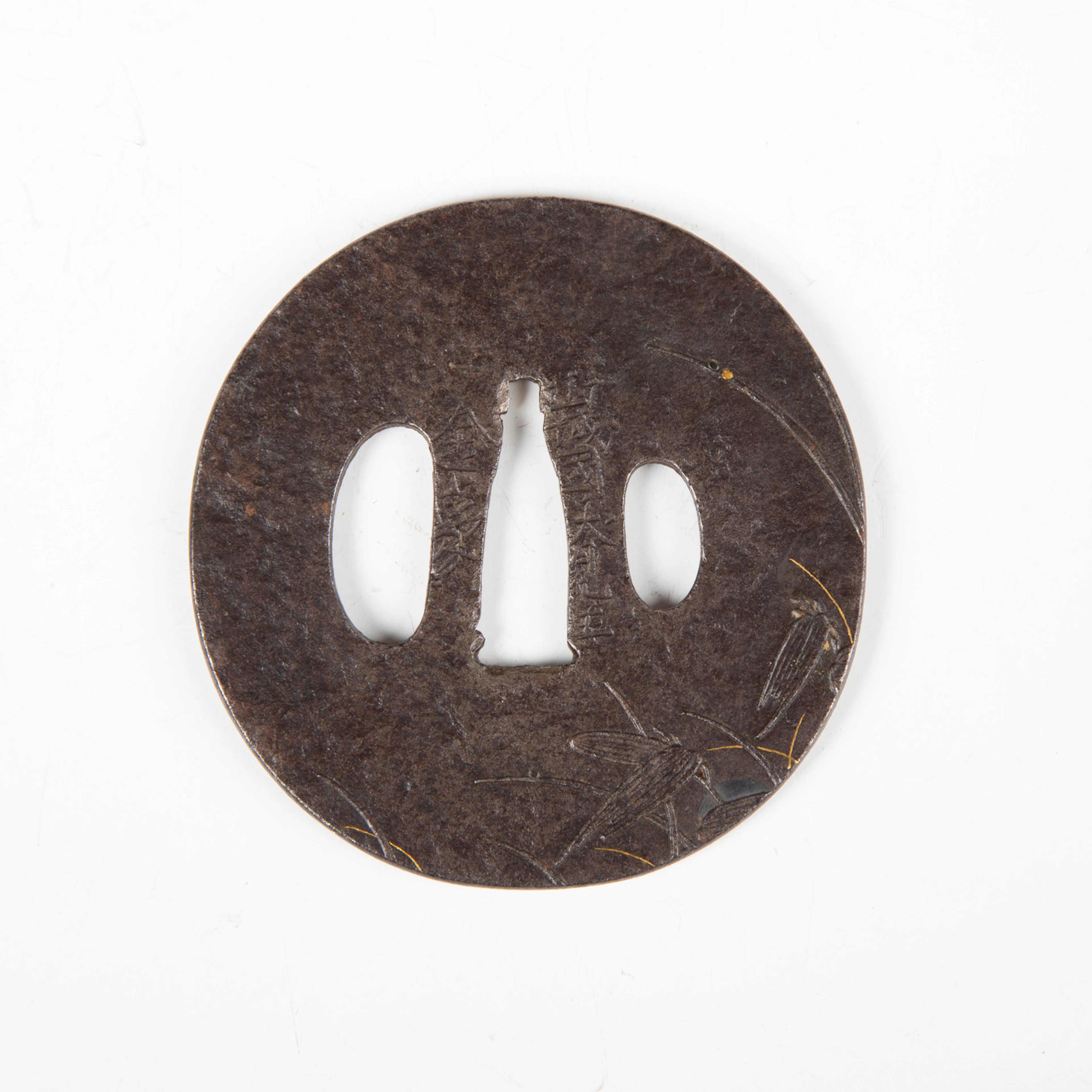 A fine Japanese circular iron and shakudo-inlaid steel sukashi tsuba