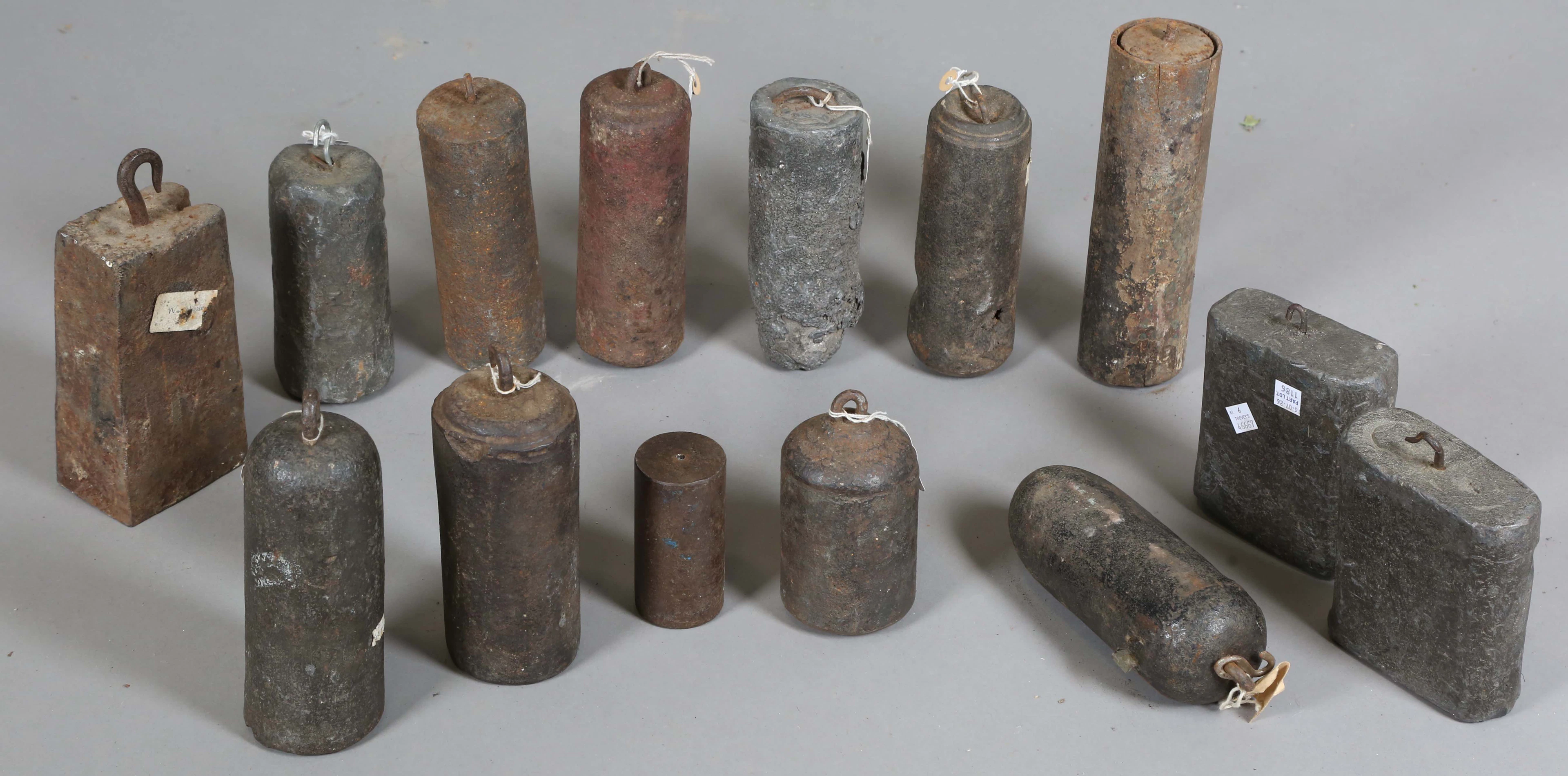 A collection of fourteen clock weights, including a pair of Tavern