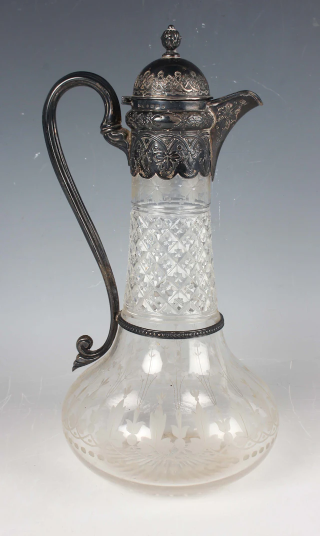 A Victorian silver mounted cut glass claret jug, the domed hinged