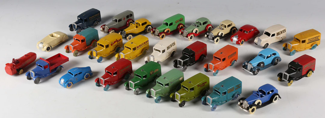 A group of Dinky Toys style vehicles, including vans, cars, truck