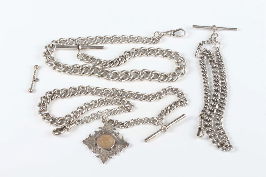 A silver graduated curblink Albert watch chain, fitted with a silver