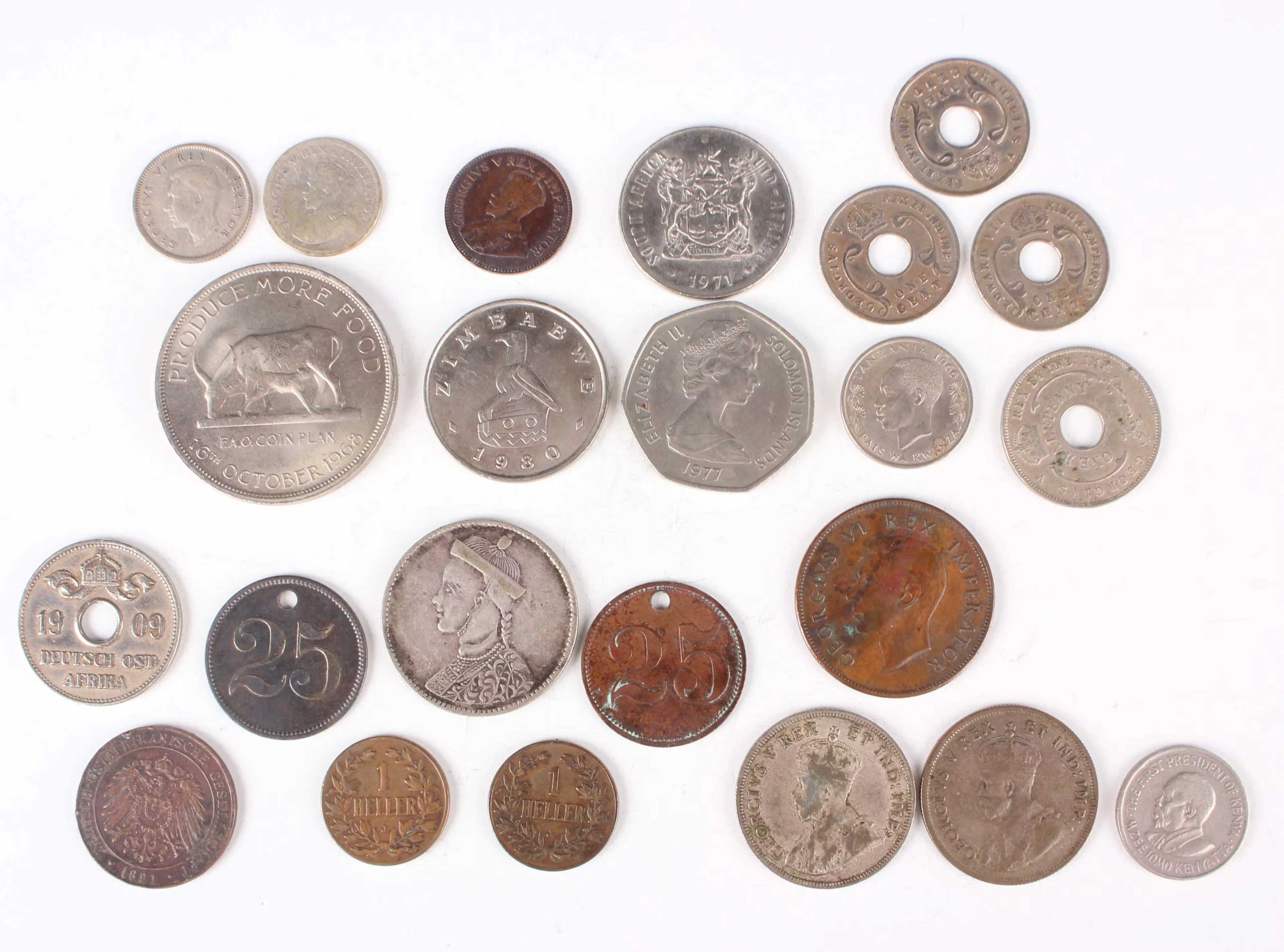 A small collection of world coinage and paranumismatic items, including
