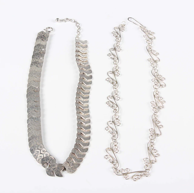 A silver necklace in a scrolling link design, length 41.5cm, and a