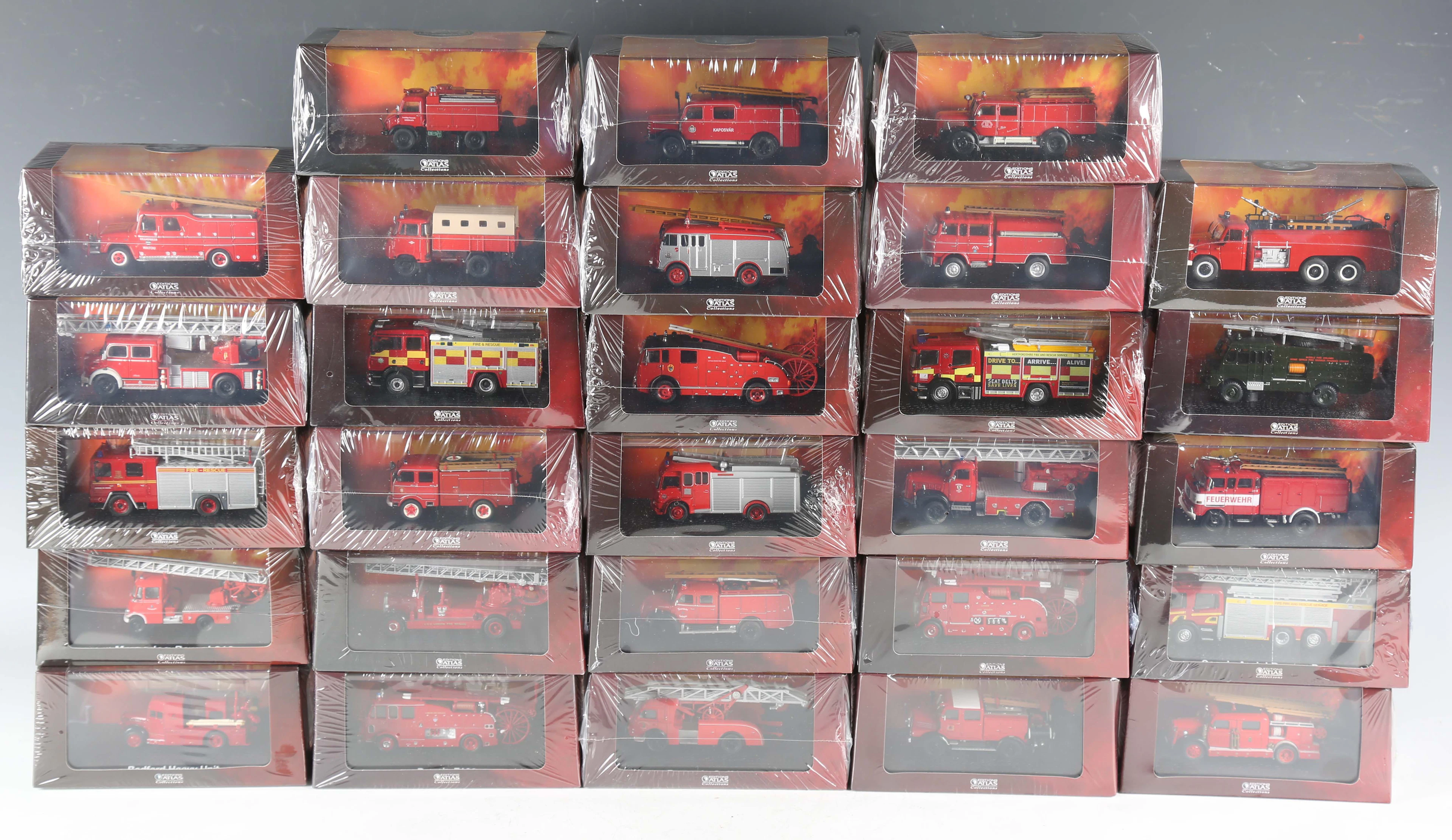 Twenty-eight Atlas Editions model fire engines, including AEC Regent
