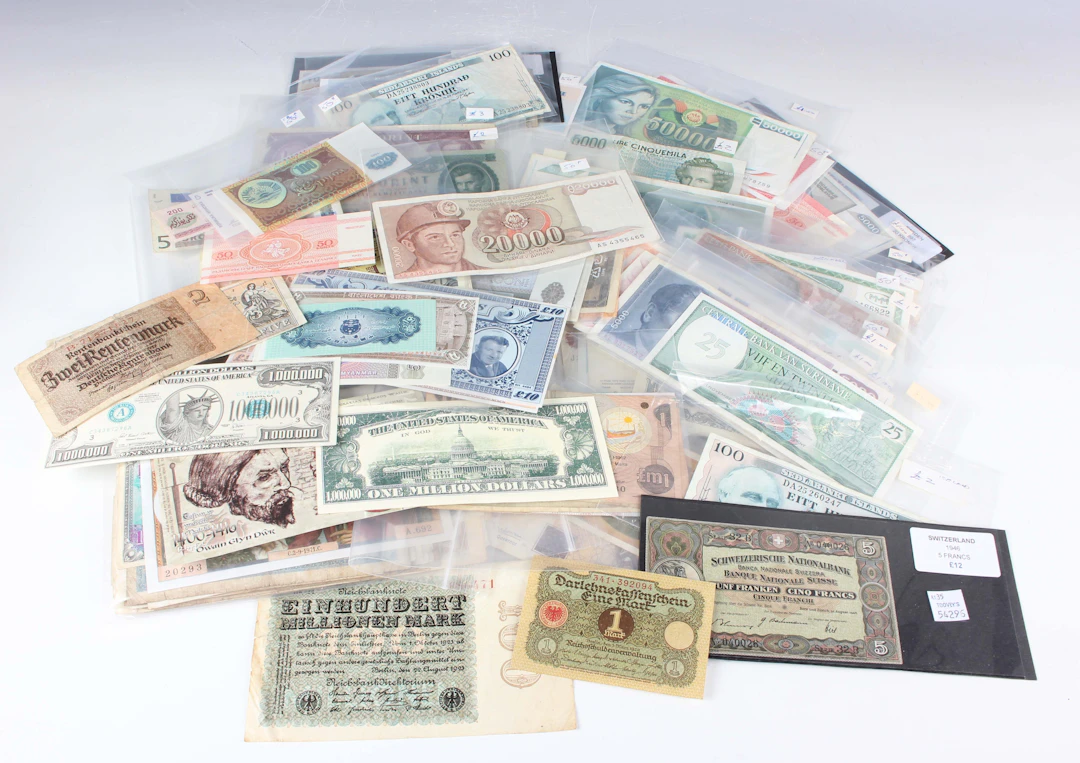 A large collection of mixed European and world banknotes, including
