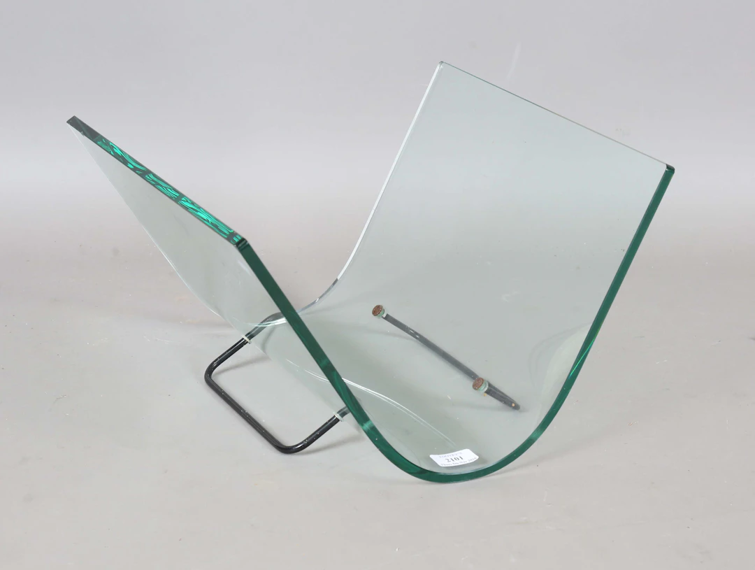 A late 20th century Italian curved glass magazine rack by Fiam, on