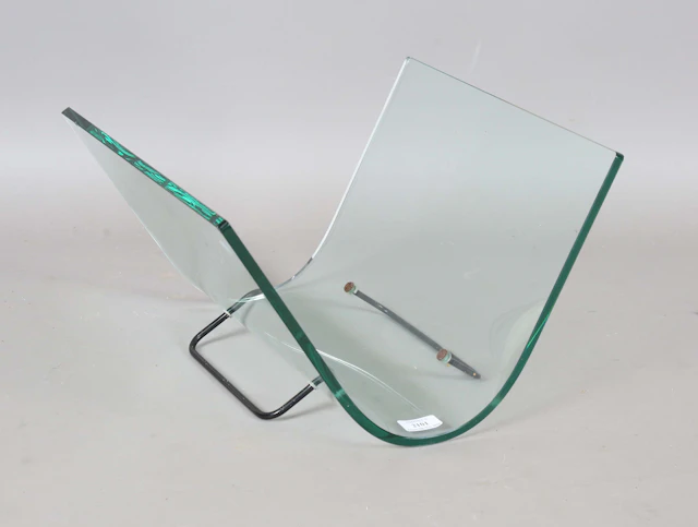 A late 20th century Italian curved glass magazine rack by Fiam, on