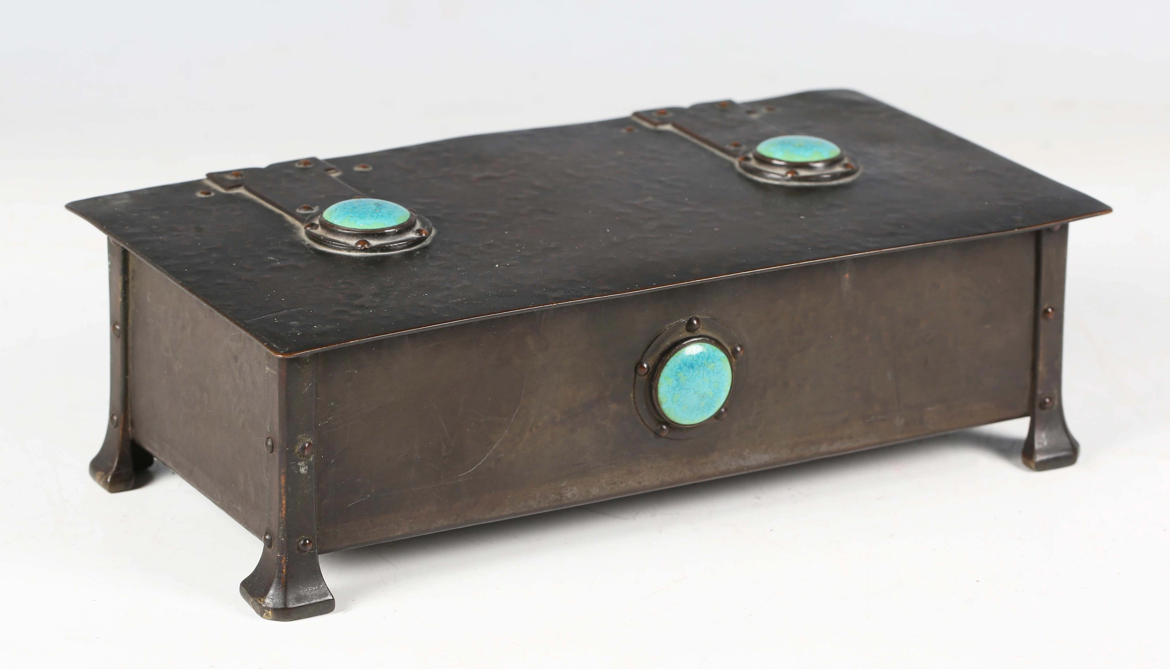 An early 20th century Arts and Crafts patinated brass box, designed