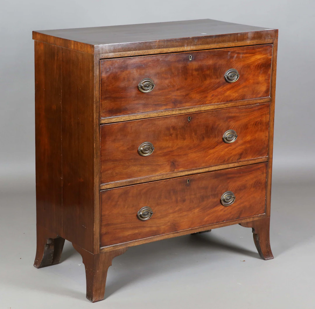 A George IV mahogany chest of three long drawers, on splayed bracket