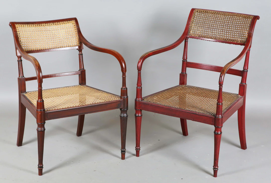 Two similar Regency red painted beech framed bergère elbow chairs