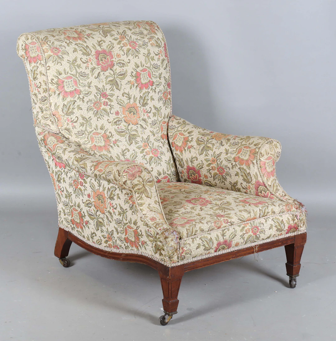 An Edwardian walnut framed scroll back armchair, in the manner of