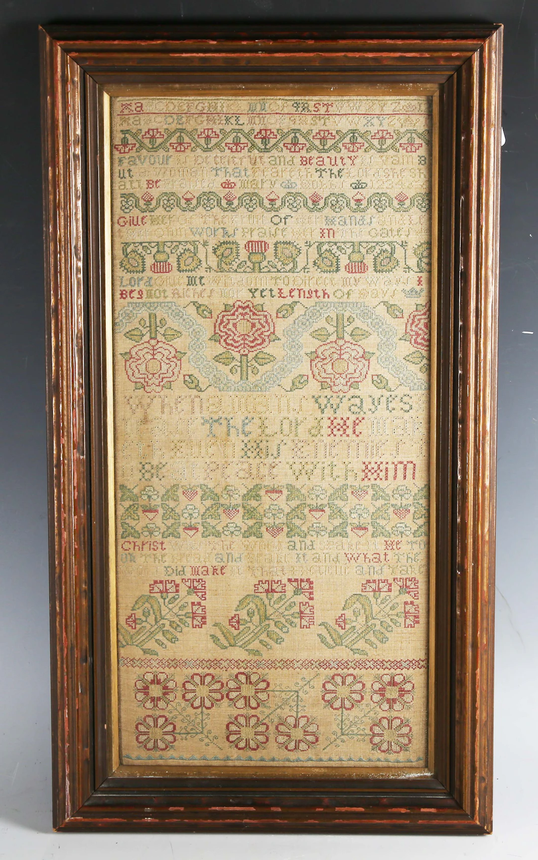 An 18th century needlework band sampler, finely worked in coloured