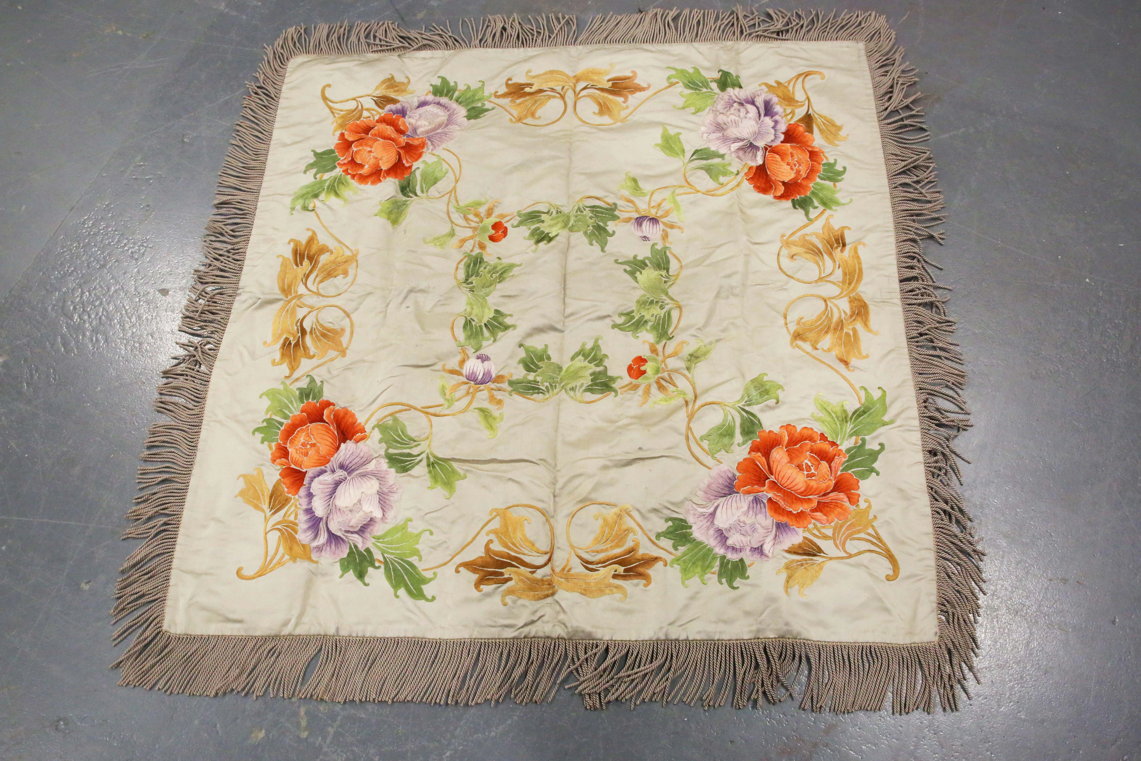 An early 20th century Japanese silk embroidered table cover, bearing