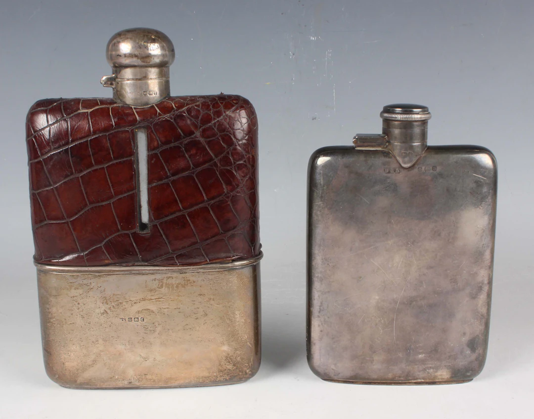 A George V silver hip flask with rotating hinged lid, Birmingham 1917