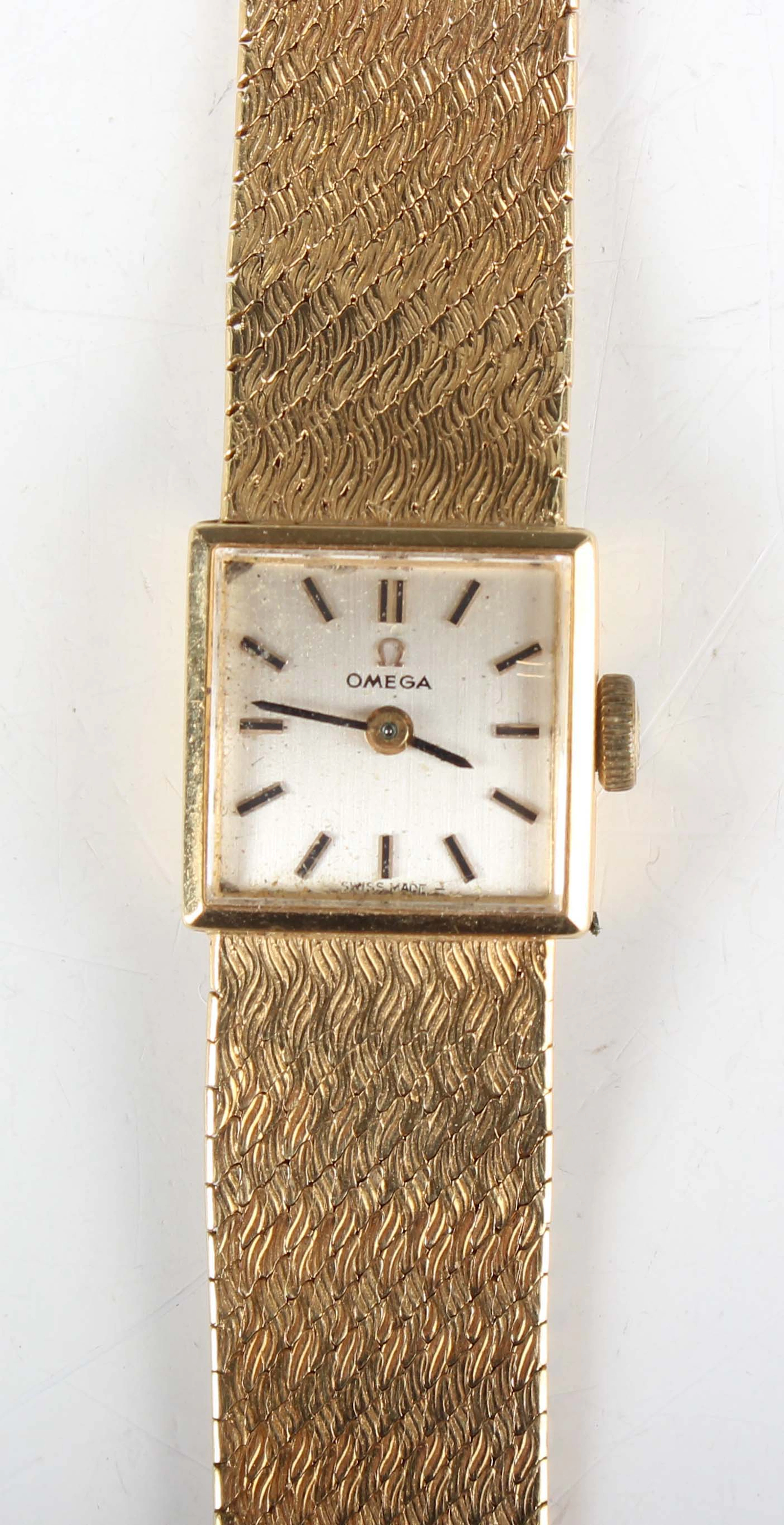 An Omega 18ct gold square cased lady's bracelet wristwatch with signed