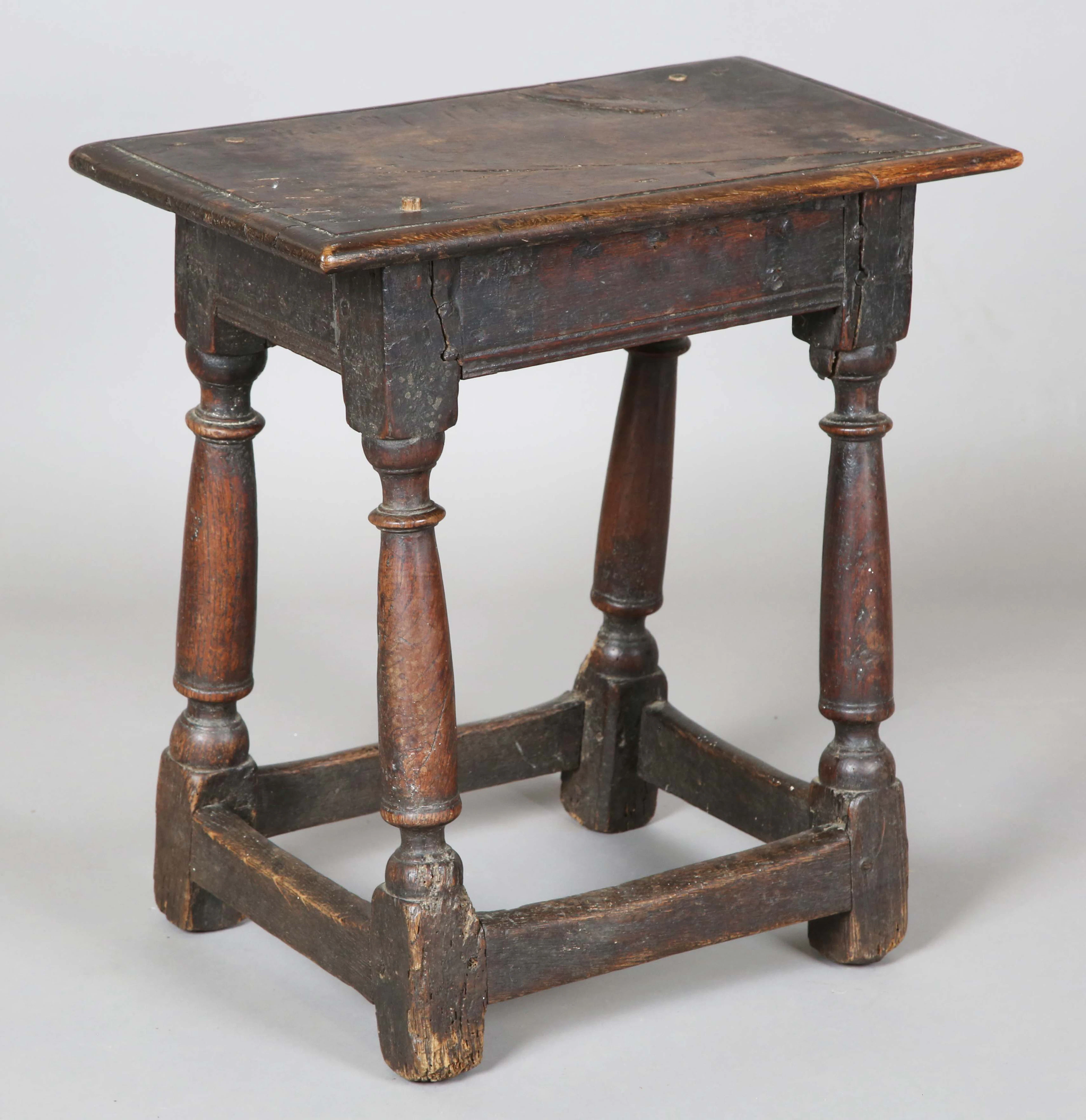 A 17th century oak joint stool, the moulded top on turned and block