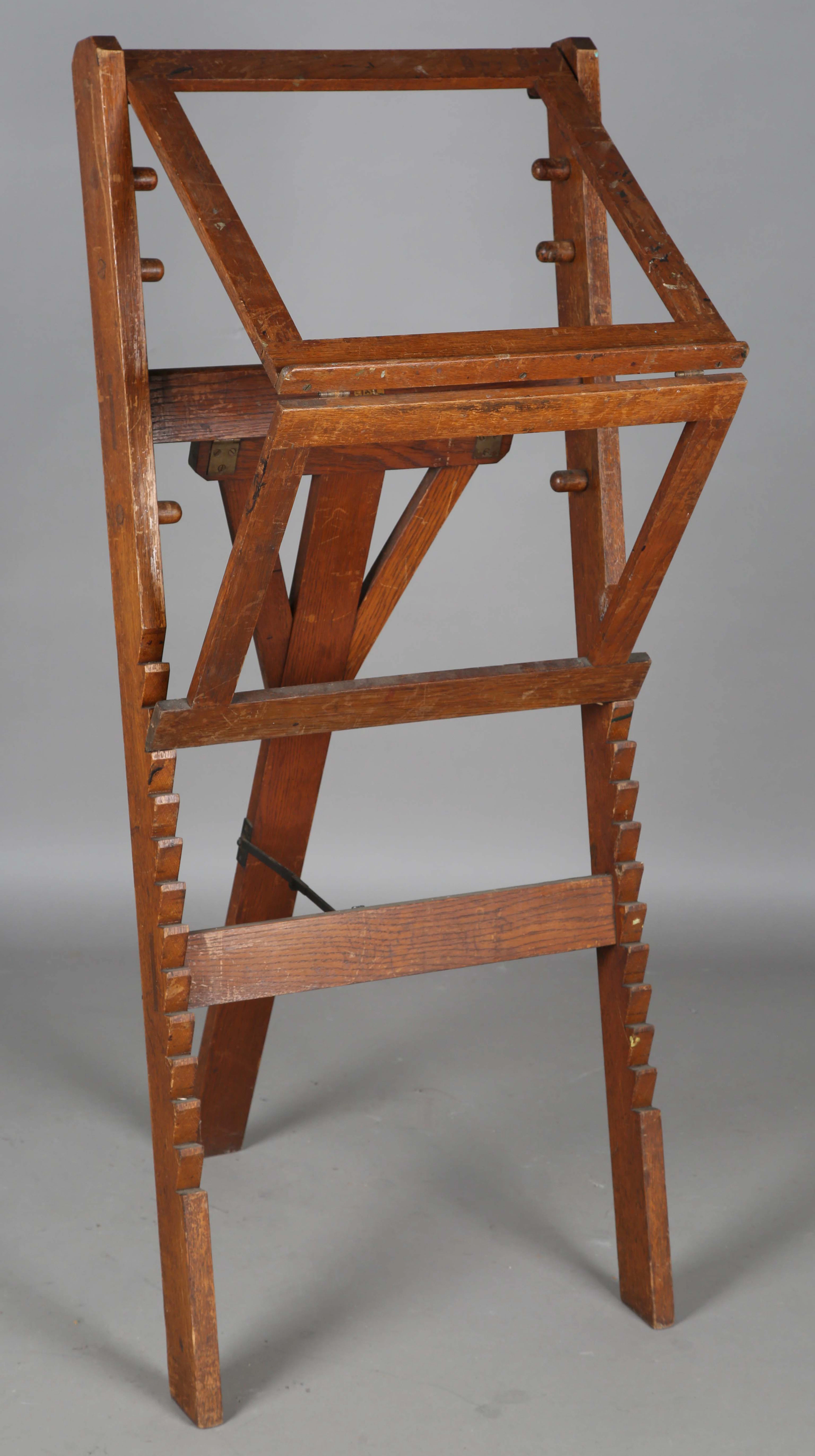 An early 20th century oak-framed artist's easel with rachet mechanism