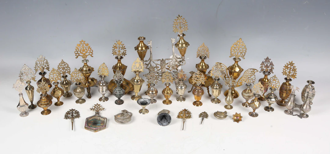 A collection of Middle Eastern brass surma dani (eyeliner containers)