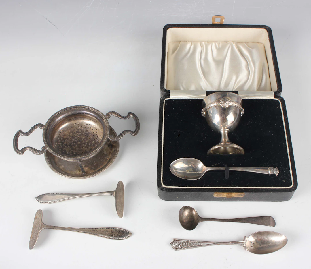 A George V silver christening egg cup and spoon, cast with Celtic