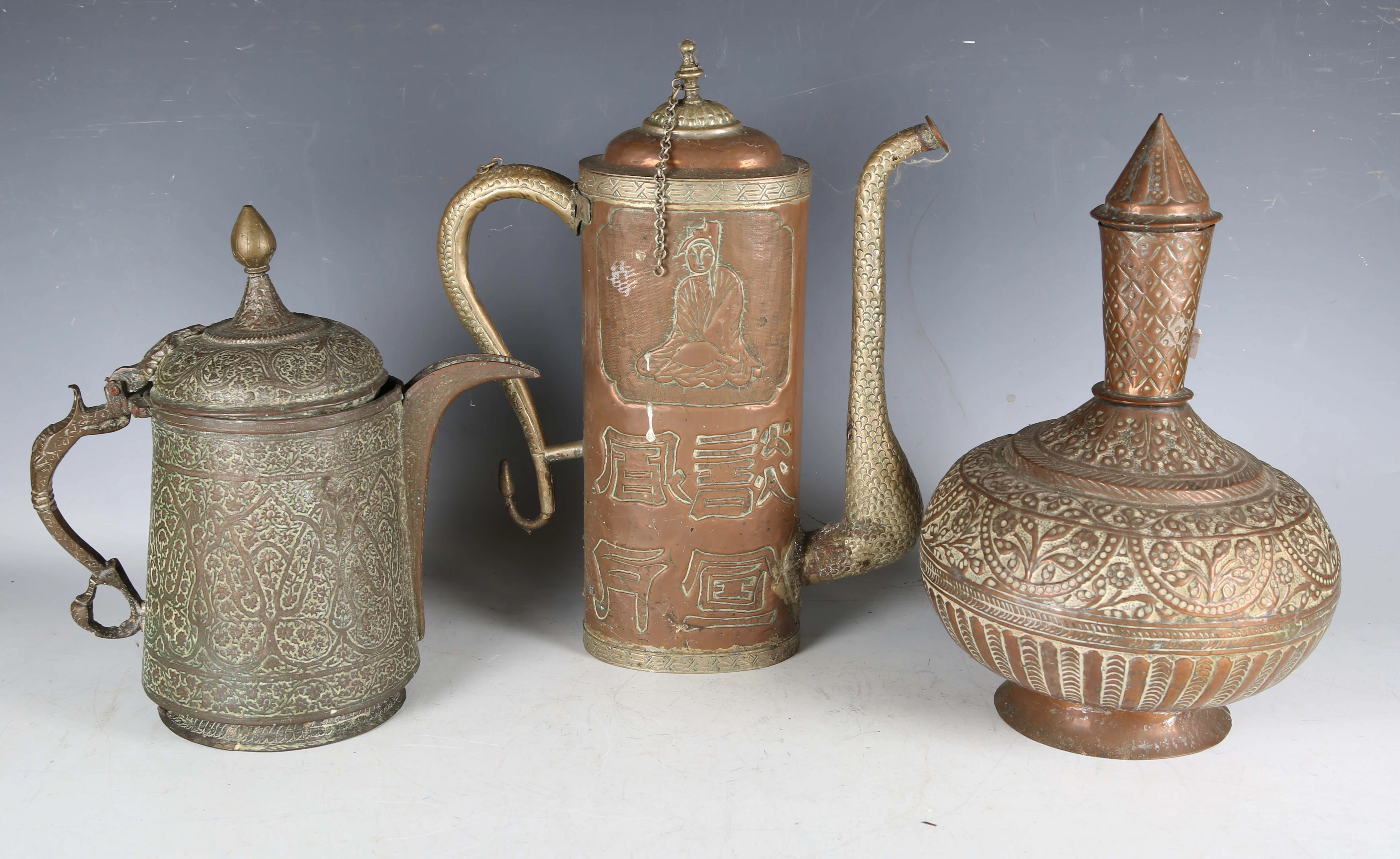 A 19th century Middle Eastern copper jug with overall foliate chased