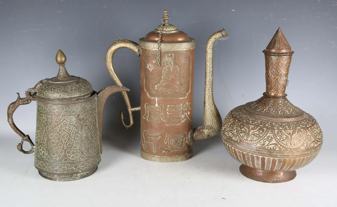 A 19th century Middle Eastern copper jug with overall foliate chased