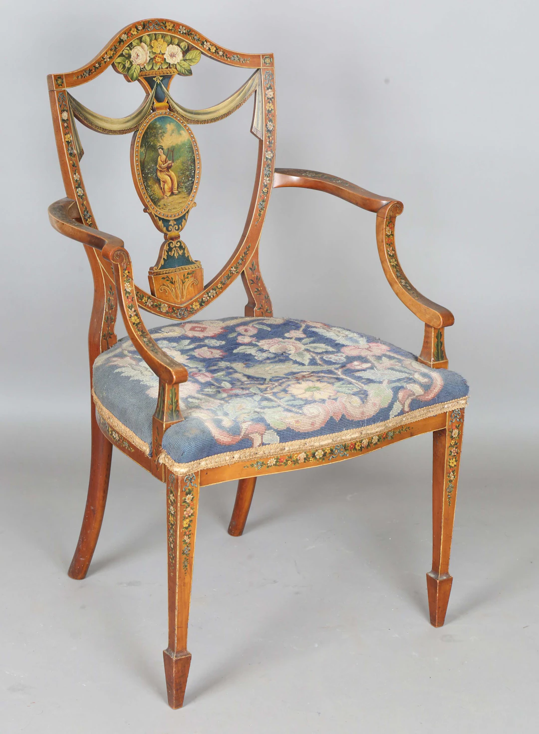 An Edwardian Neoclassical Revival mahogany framed elbow chair with