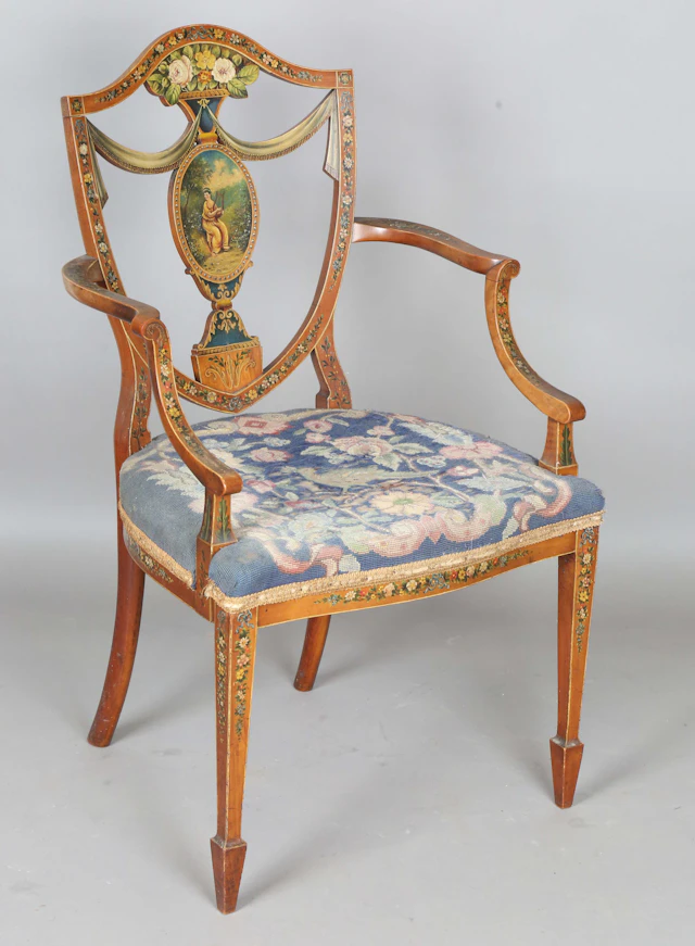 An Edwardian Neoclassical Revival mahogany framed elbow chair with