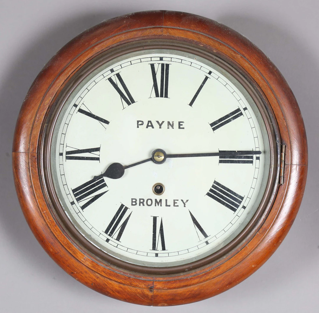An early 20th century stained beech circular cased wall timepiece
