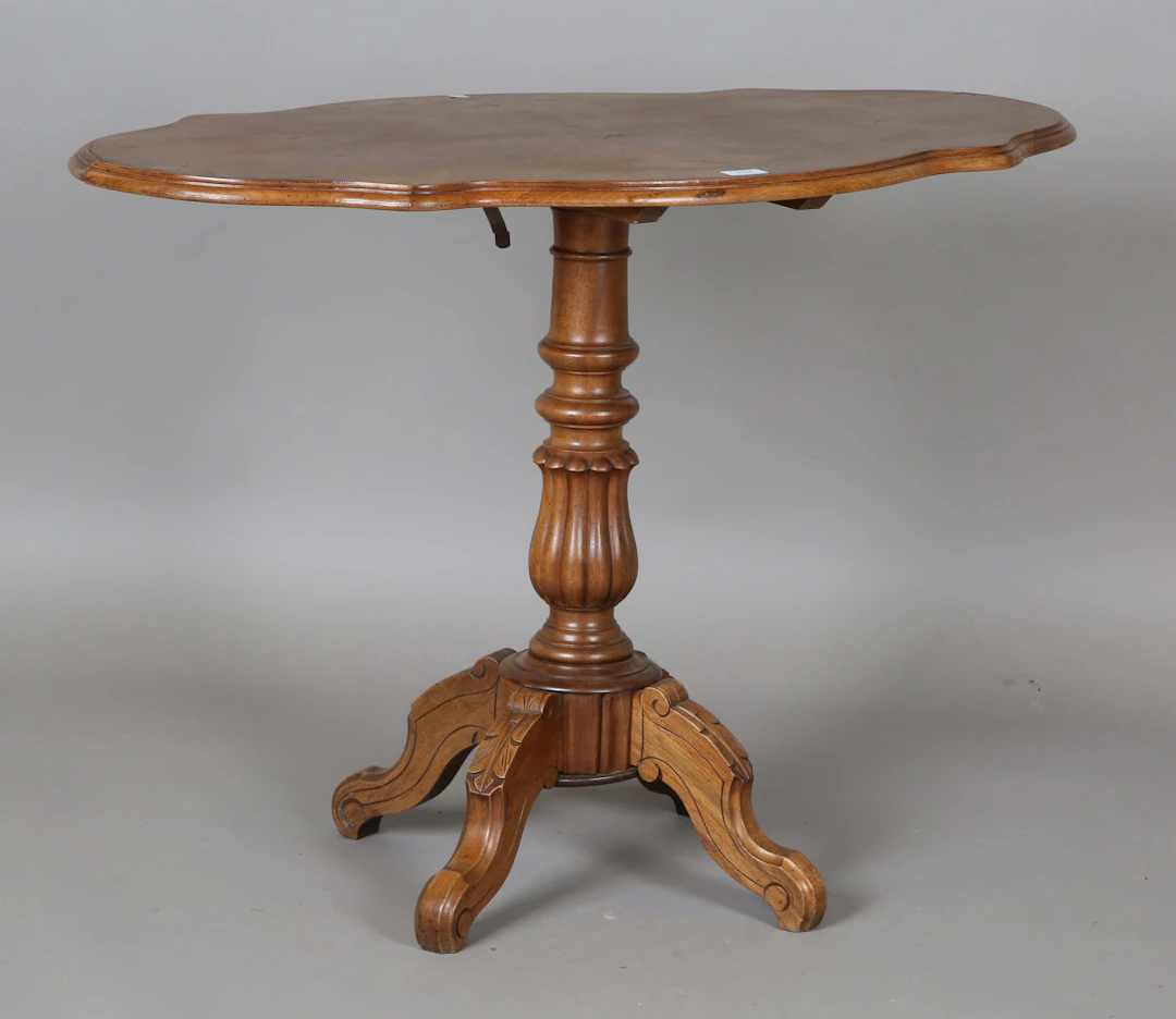 An early 20th century French walnut shaped oval tip-top occasional