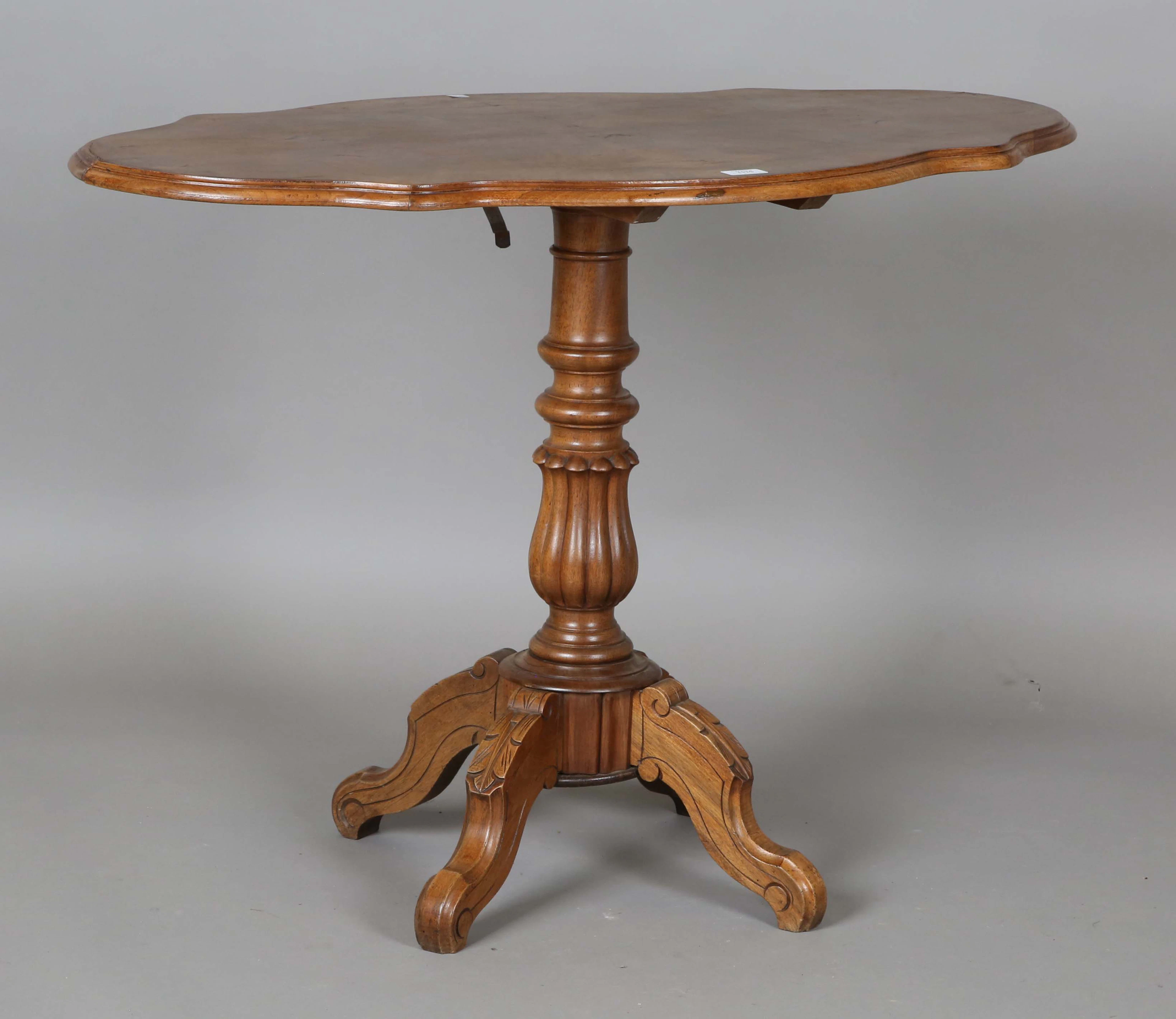 An early 20th century French walnut shaped oval tip-top occasional