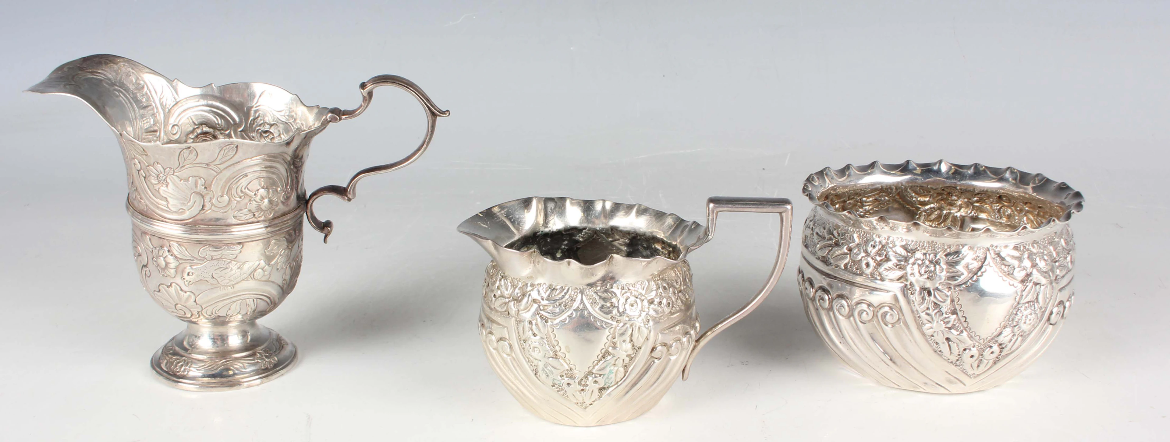 A late Victorian silver cream jug and matching sugar bowl of spiral